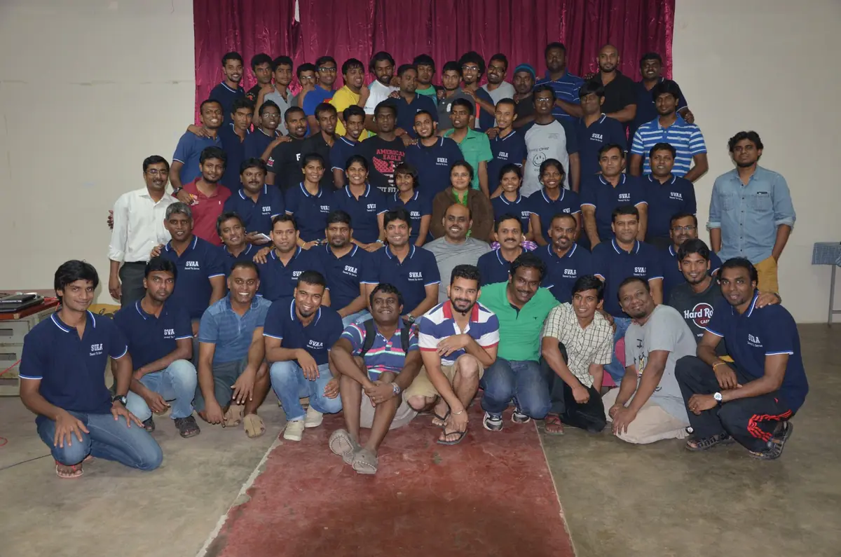 SVAA alumni gathered for a group photo in matching navy shirts